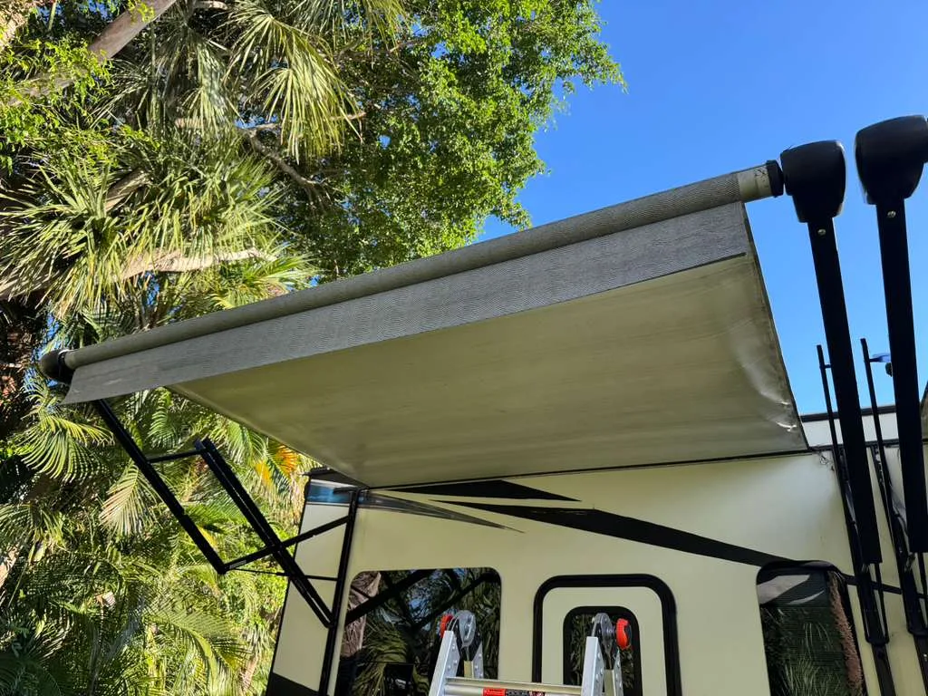 Mission RV technician replacing an RV awning at a Florida campground