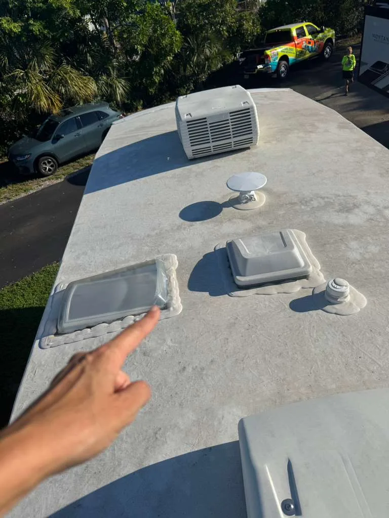 Mission RV technician repairing a rubber roof leak on an RV in Florida