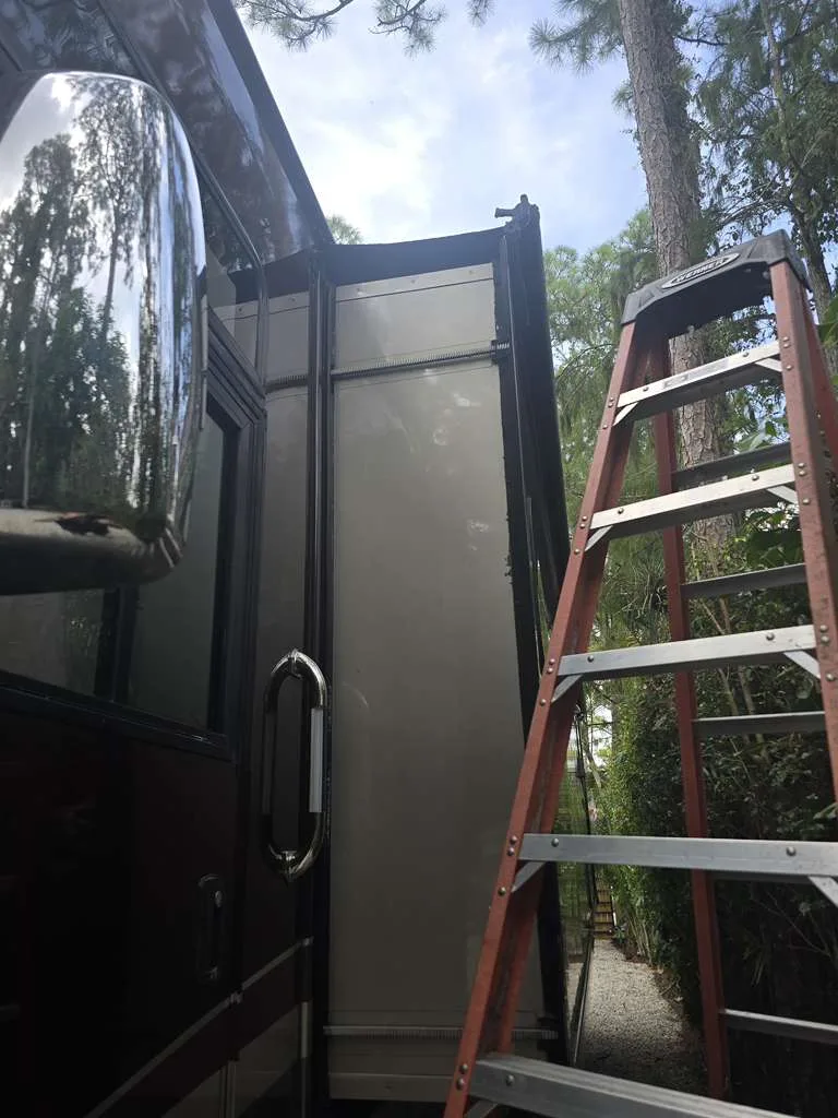 Mission RV technician working on a stuck slide-out at a Florida campsite