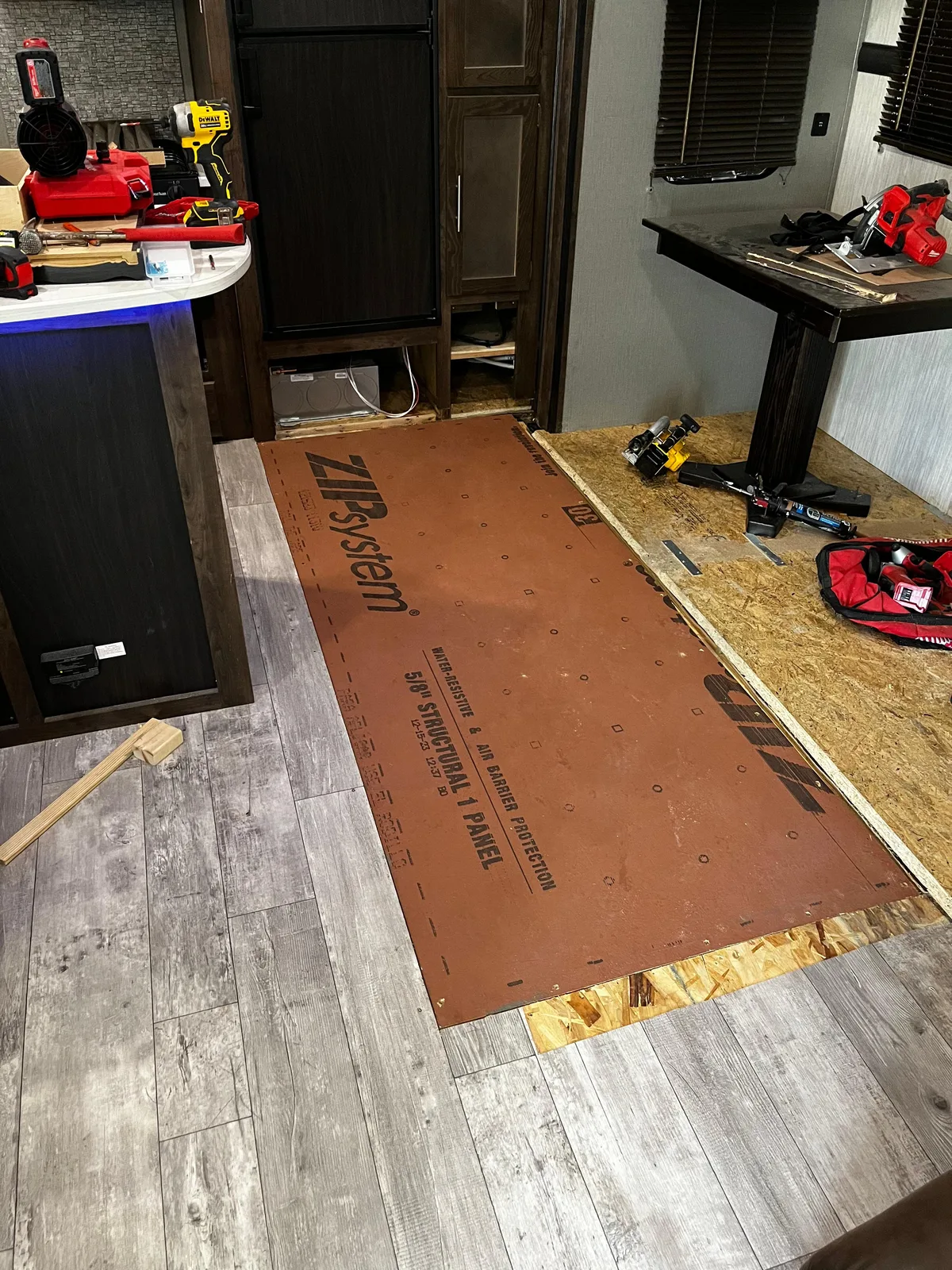 Mission RV technician fixing the floor after a water leak inside an RV